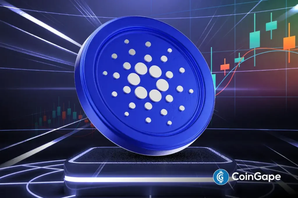 Moeda azul do Cardano (ADA) em destaque sobre fundo com gráfico de candles de criptomoedas